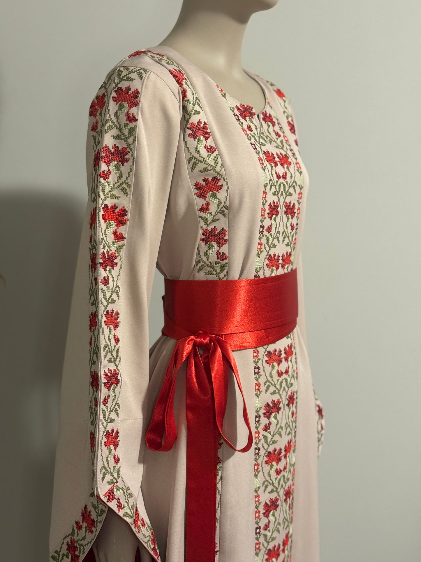 A beautiful beige and red dress with fashionable sleeves.