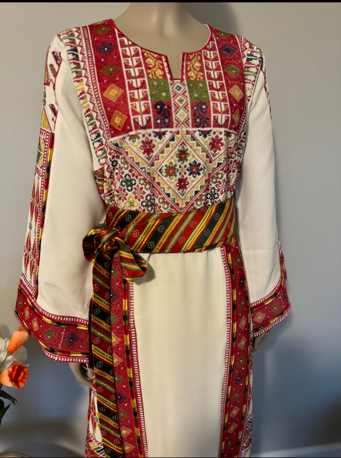 White thobe with colorful embroidery
