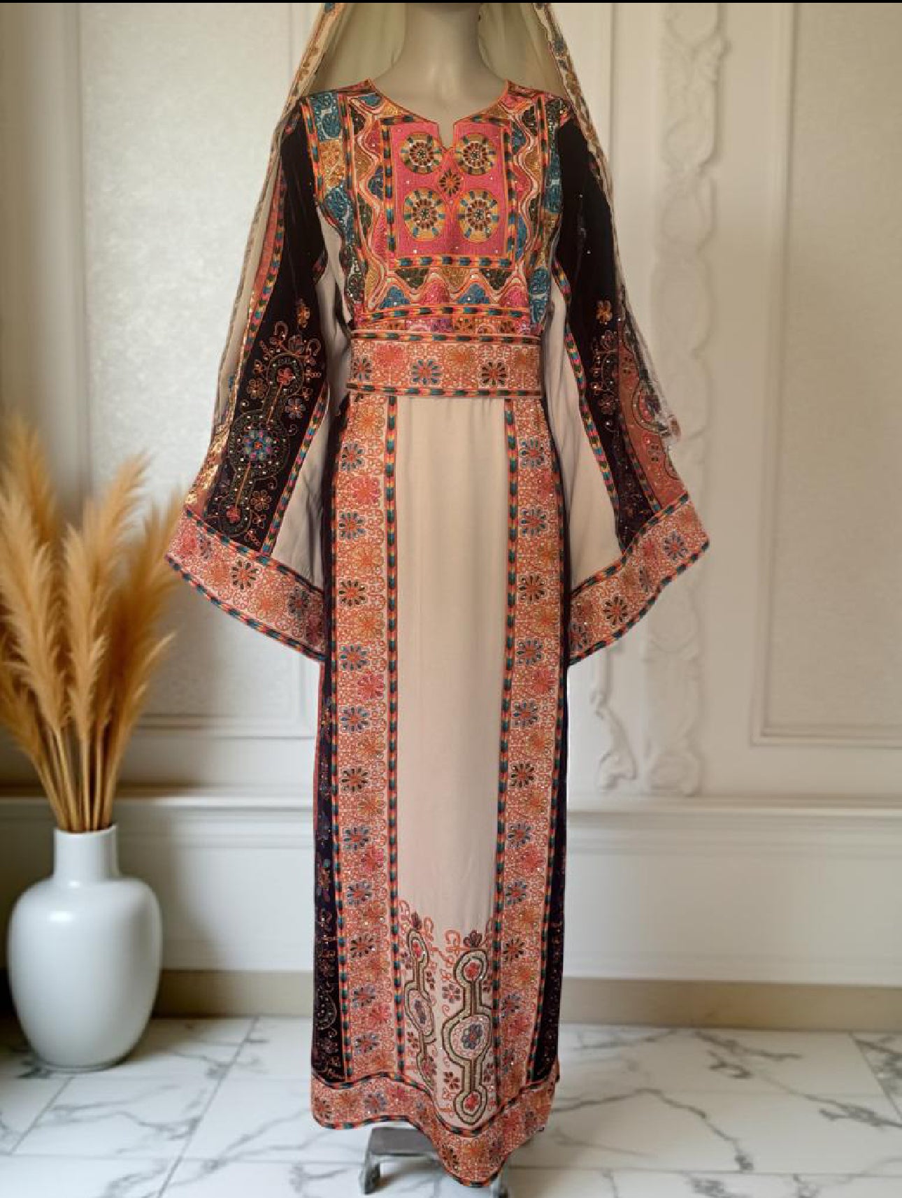 Cream thobe with burgundy velvet and orange satin accents.