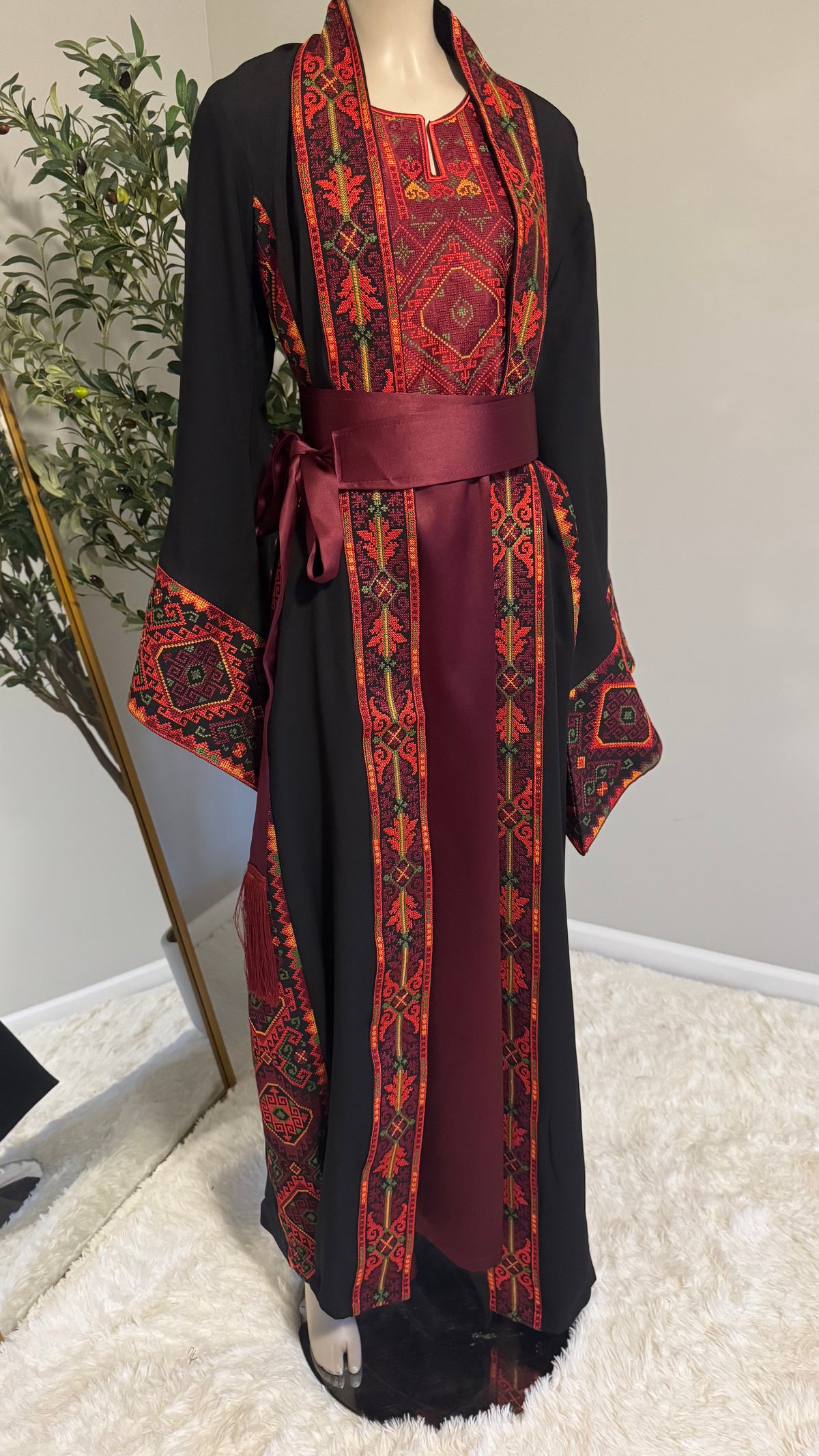 Black and burgundy two-piece abaya with a matching belt.