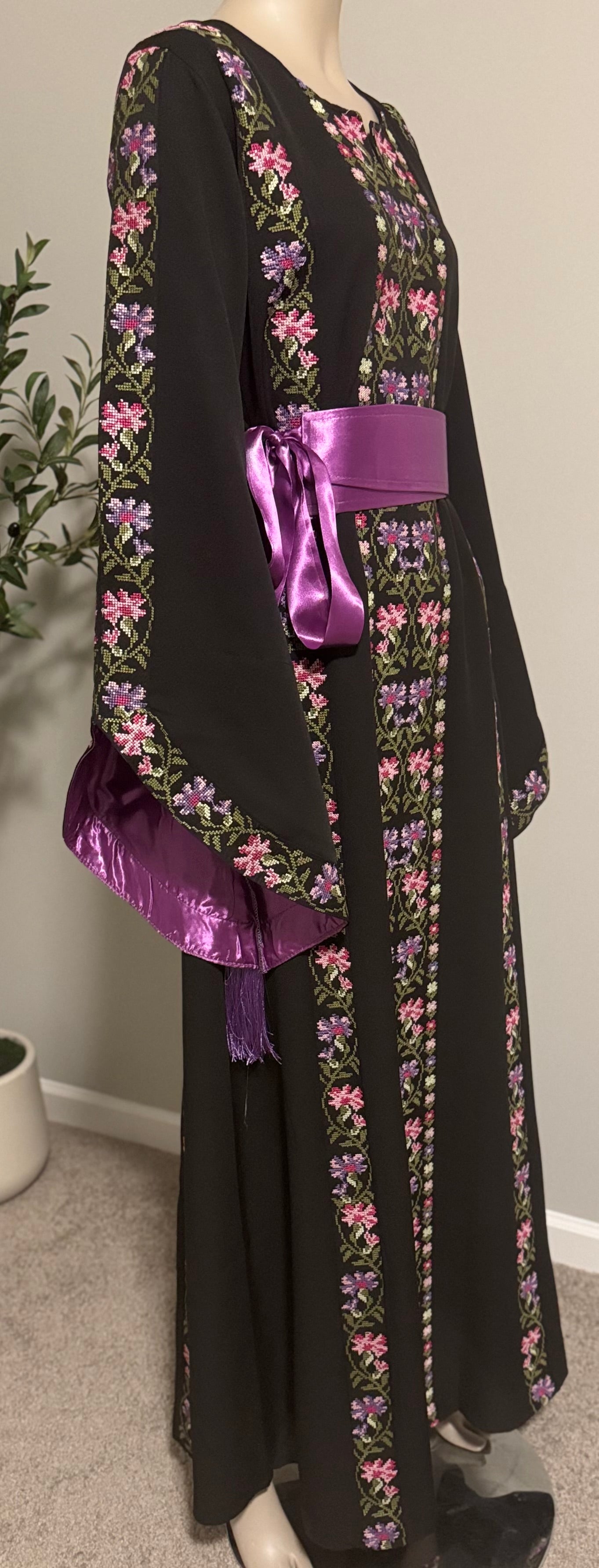 A beautiful black and purple dress with fashionable sleeves.