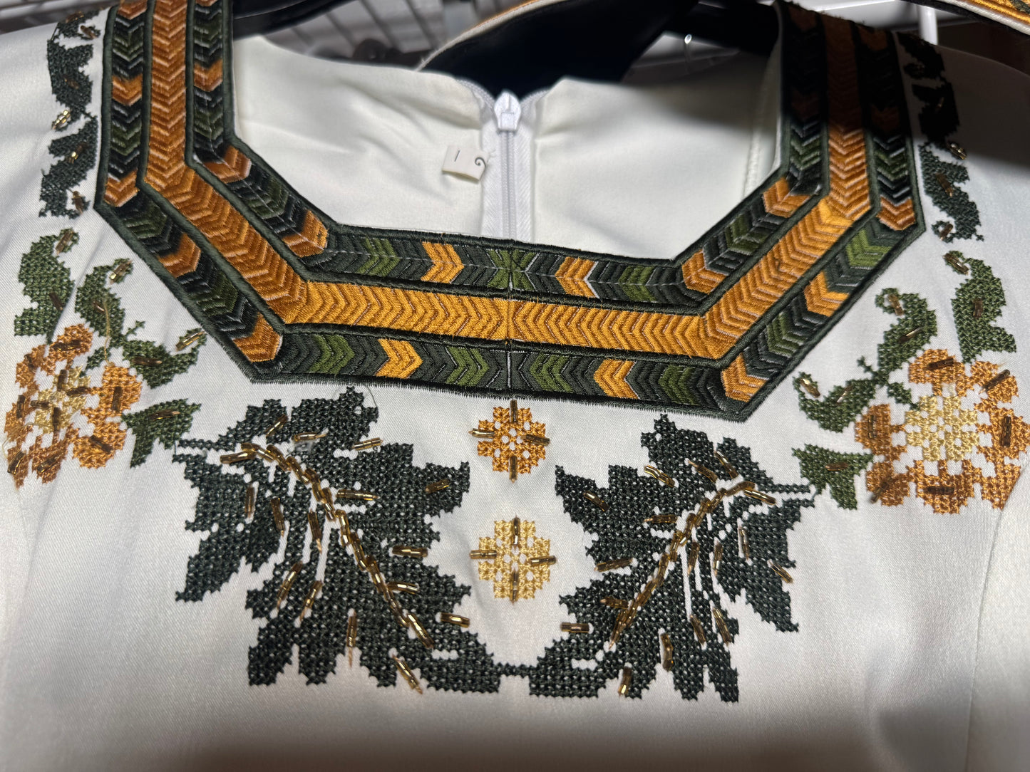Elegant white dress with green and gold embroidery