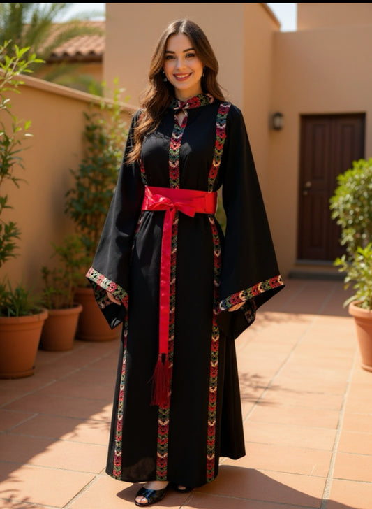 Black dress with embroidery and satin belt.
