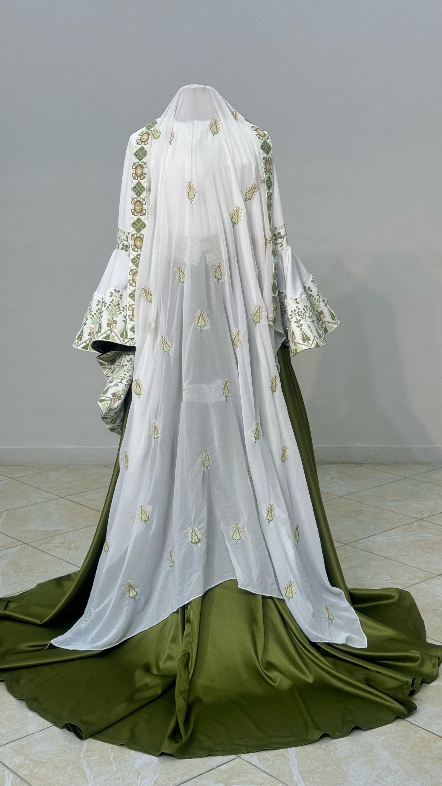 Embroidered white and green dress with overskirt.