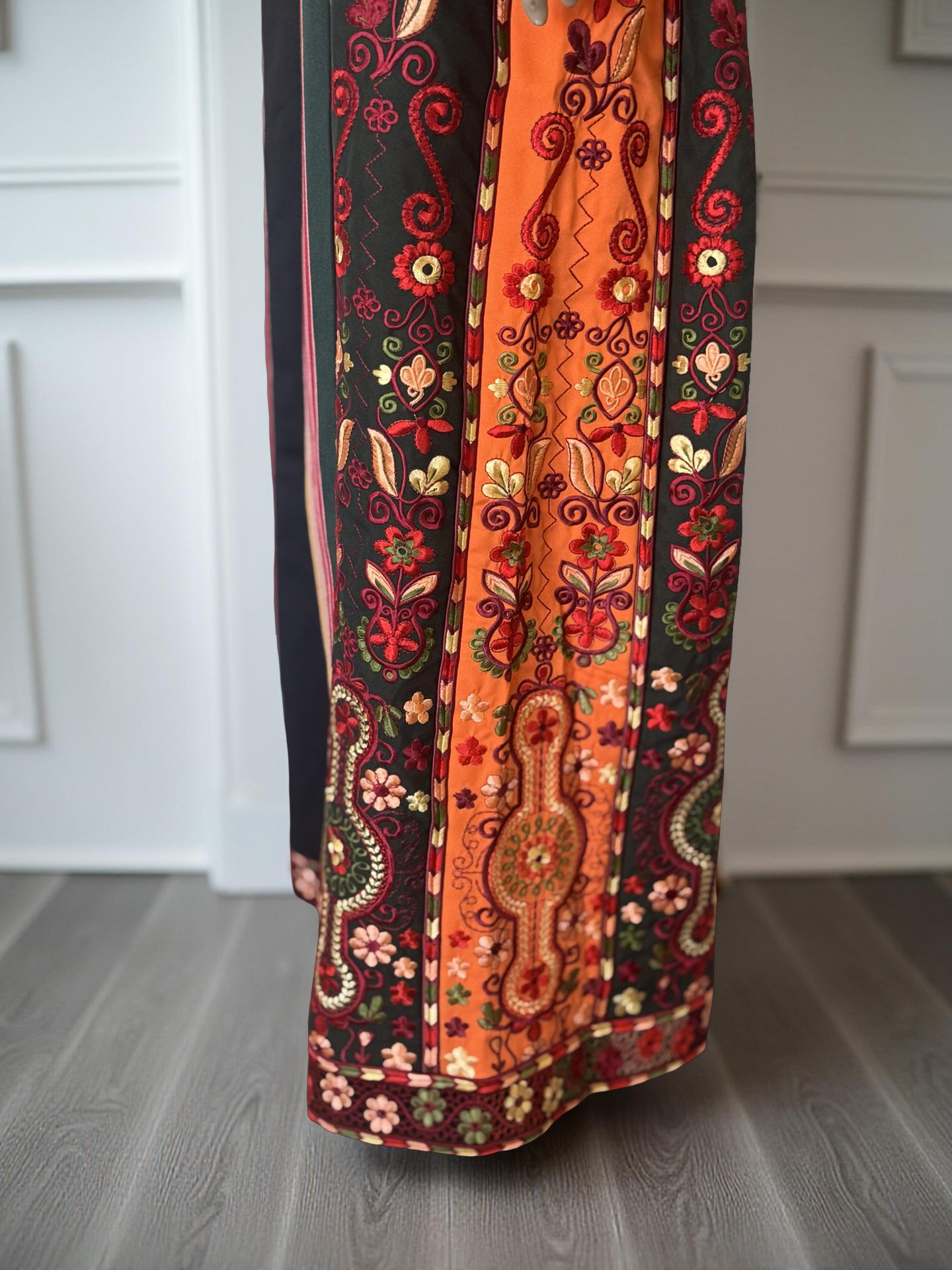 Black majdalwee thobe with orange and green fabric.