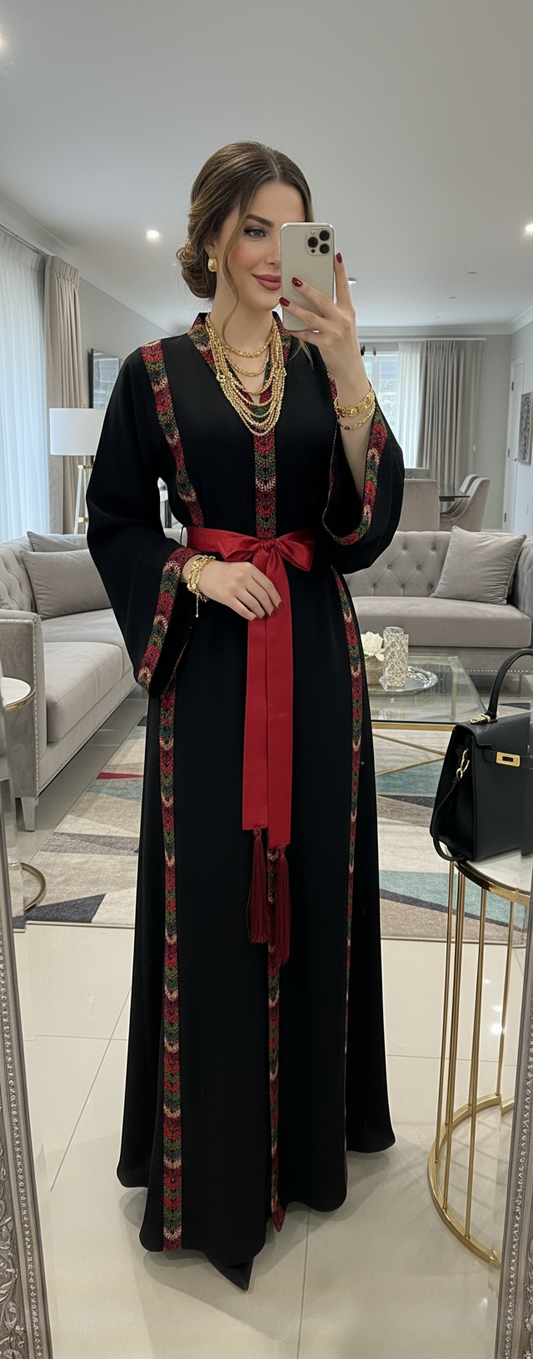 Black dress with embroidery and satin belt.